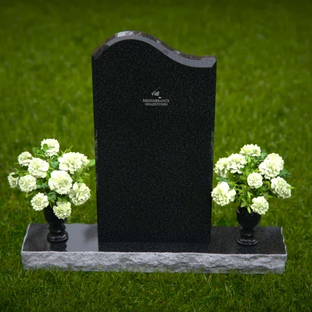 Elegant upright headstones with floral arrangement for timeless tribute.