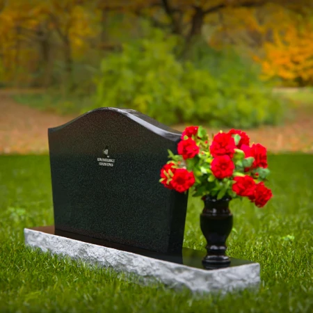 Waved granite headstones with single flower vase for graceful tribute.