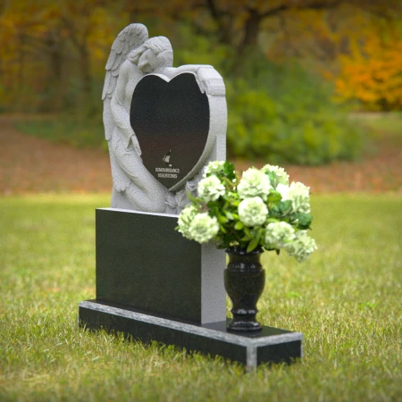 Granite angel heart headstones with floral vases for loving memorials.