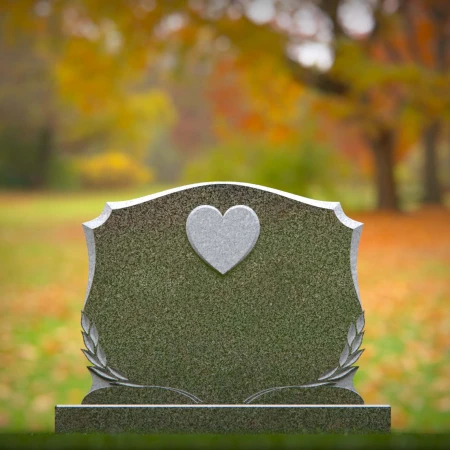 Memorial artistry flows through heart and leaf designs in headstones