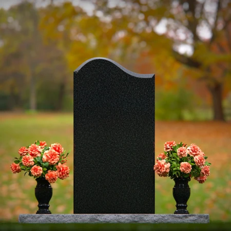 Elegant upright headstones with floral arrangement for timeless tribute.