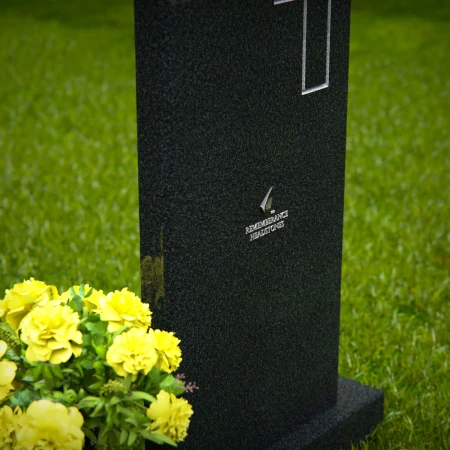 Upright granite headstones with cross design and flower vase.