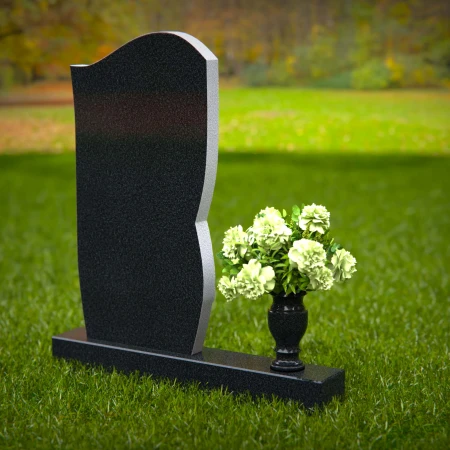 Artistic headstones with unique curved design and flower vase.