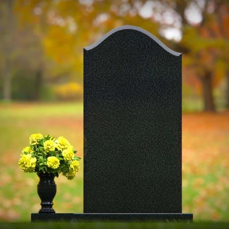 Elegant single granite headstones with curved top and flower vase.