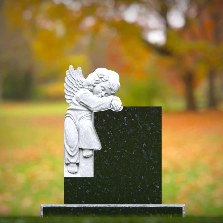 Carved children’s headstones with quiet angel watching over