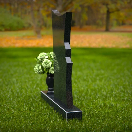 Contemporary headstones featuring a flowing design and floral vase.