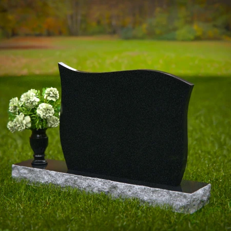 Contoured granite headstones with polished finish and flower vase.