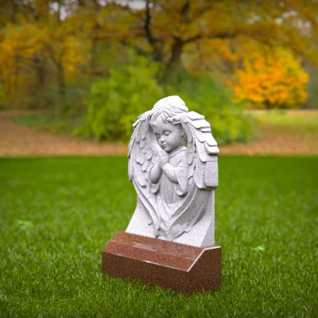 Reflective child tombstones carved with kneeling cherub angel