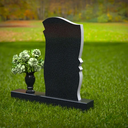 Elegant granite headstones with curved design and flower vase.