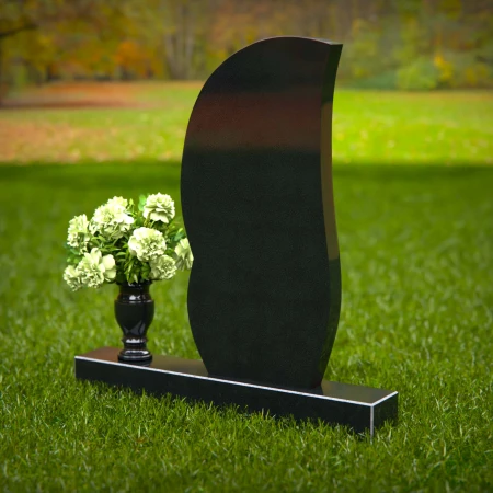 Modern curved headstones with single flower vase for memorials.