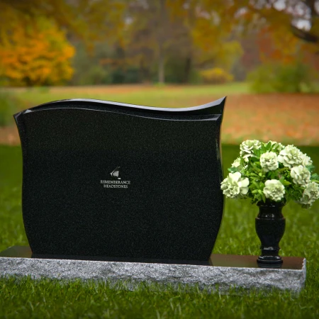 Contoured granite headstones with polished finish and flower vase.