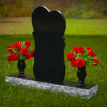 Unique dual heart headstones with twin flower vases for memorials.