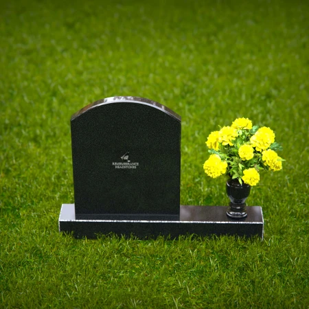 Classic arched granite headstones with polished vase tribute.