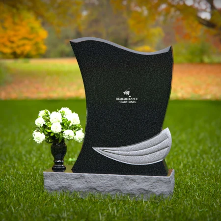 Elegant granite headstones with flowing contoured design and flower vase.