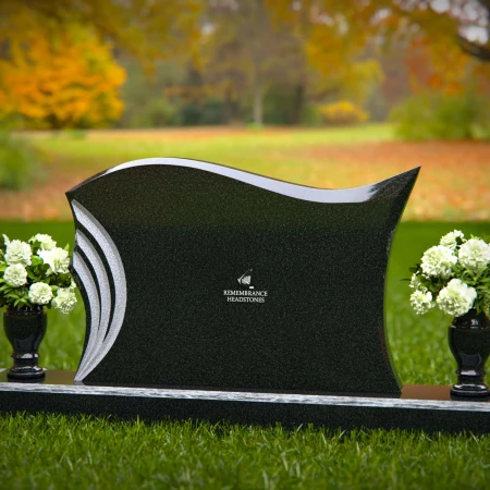 Elegant curved headstones with artistic detailing for a timeless tribute.