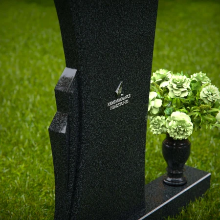 Contemporary headstones featuring a flowing design and floral vase.