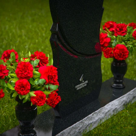 Unique dual heart headstones with twin flower vases for memorials.