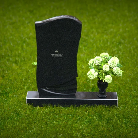 Elegant curved granite headstones with layered detailing for timeless memorials.