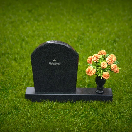 Classic arched granite headstones with single flower vase tribute.