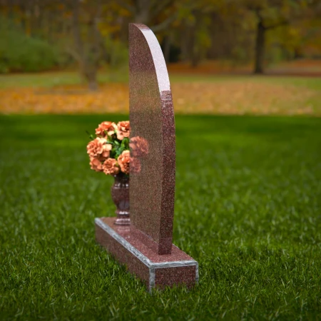 Contemporary headstones featuring sleek curves and floral vases.
