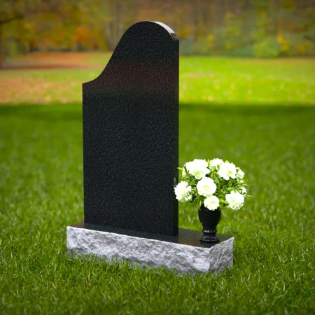 Elegant sloped headstones with floral vase for timeless tribute.