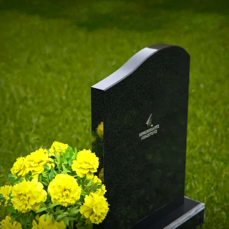 Elegant granite headstones with gently curved top and flower vase.