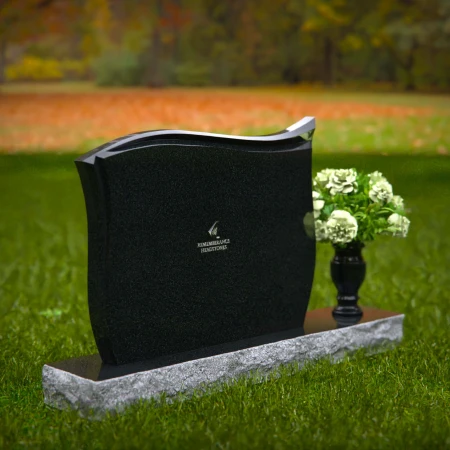Contoured granite headstones with polished finish and flower vase.