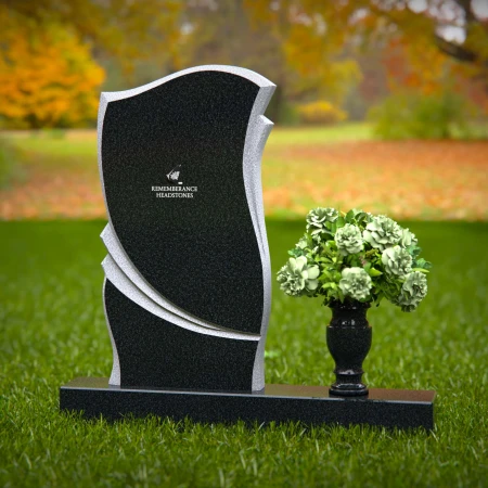 Elegant granite headstones with curved design and flower vase.