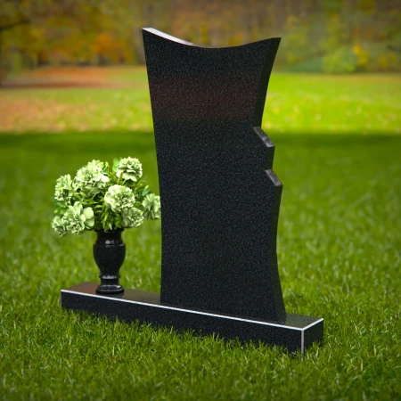 Contemporary headstones featuring a flowing design and floral vase.