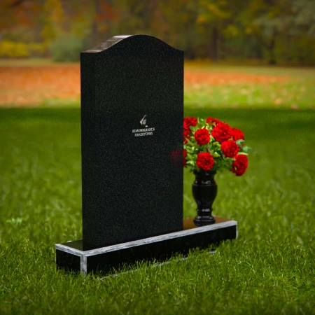 Classic granite headstones with arched top and flower vase.