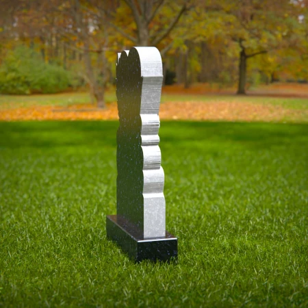Soaring grace and loving shape unite in dove-heart tombstones