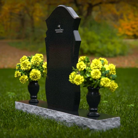 Unique shaped headstones with dual flower vases for memorial tribute.