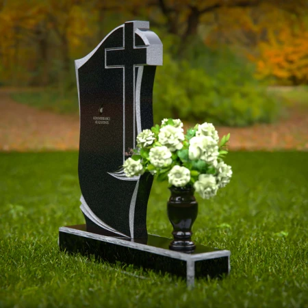 Traditional granite headstones with cross design and flower vase.
