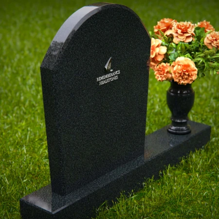 Classic arched granite headstones with single flower vase tribute.