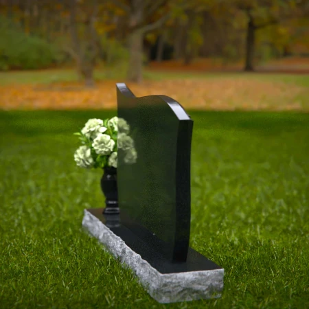 Contoured granite headstones with polished finish and flower vase.