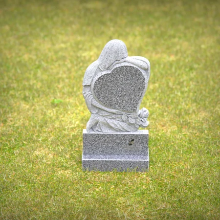 Heart-shaped gray granite headstone with angel design — a touching memorial tribute.