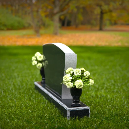 Elegant double vase headstones with contoured design for tribute.