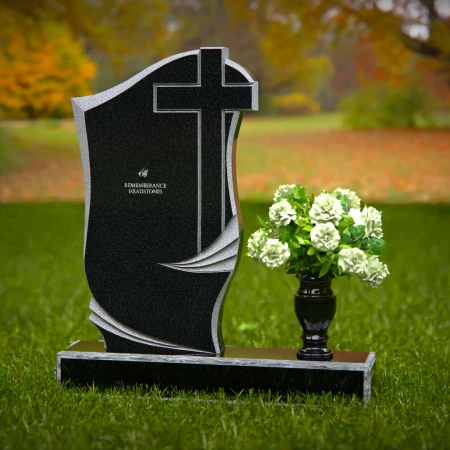 Traditional granite headstones with cross design and flower vase.