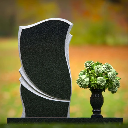 Elegant granite headstones with curved design and flower vase.