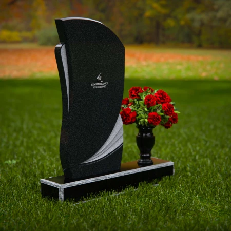 Modern headstones with artistic curves and a matching floral vase.
