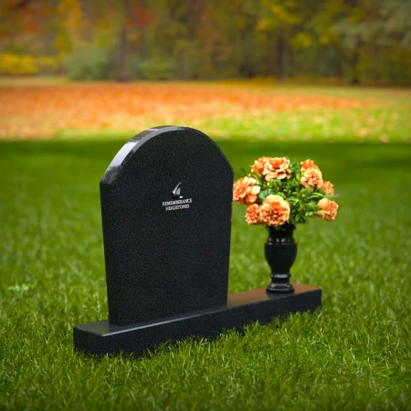 Classic arched granite headstones with single flower vase tribute.