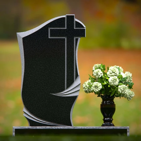 Traditional granite headstones with cross design and flower vase.