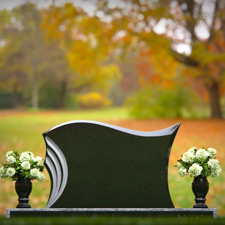 Elegant curved headstones with artistic detailing for a timeless tribute.