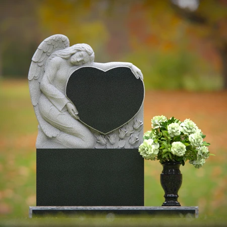 Granite angel heart headstones with floral vases for loving memorials.