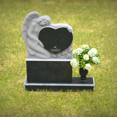Granite angel heart headstones with floral vases for loving memorials.