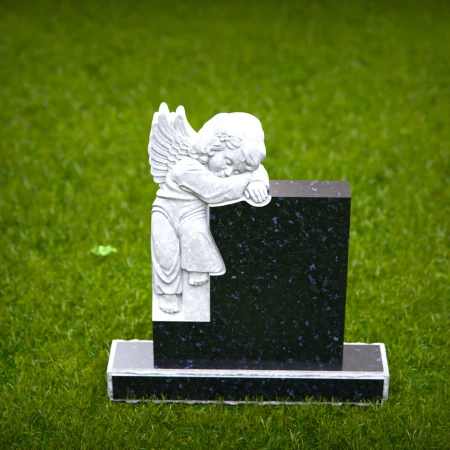 Carved children’s headstones with quiet angel watching over
