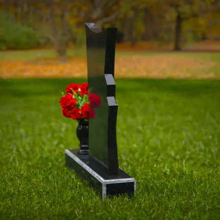 Contemporary granite headstones with unique shape and flower vase.