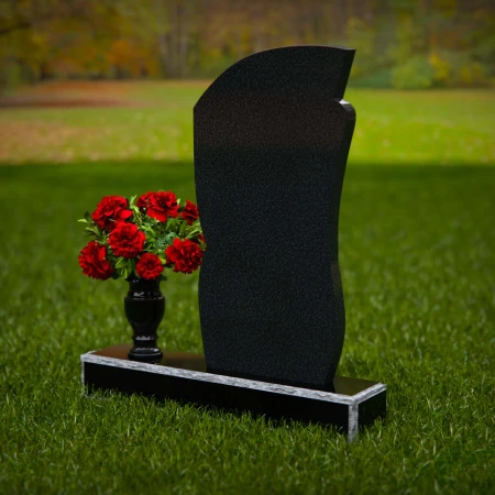 Modern headstones with artistic curves and a matching floral vase.