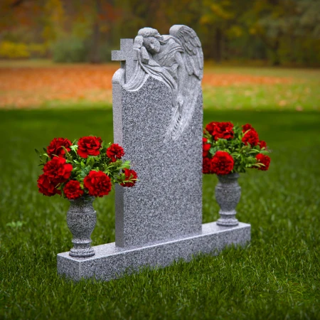 1911 - Angel Monument Embracing Cross with Floral Tributes
