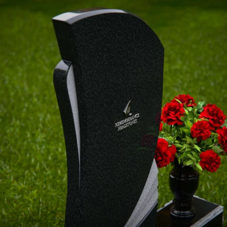 Modern headstones with artistic curves and a matching floral vase.
